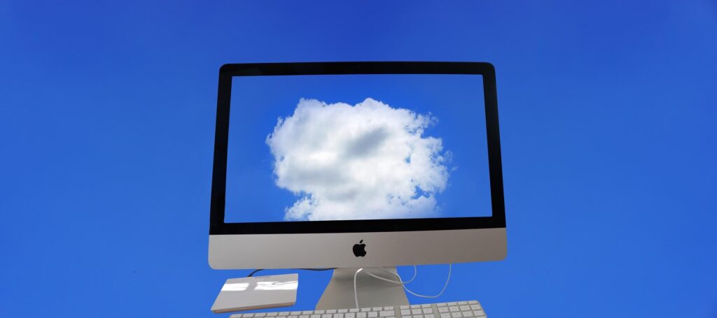 A computer with a cloud on the screenAI-generated content may be incorrect.